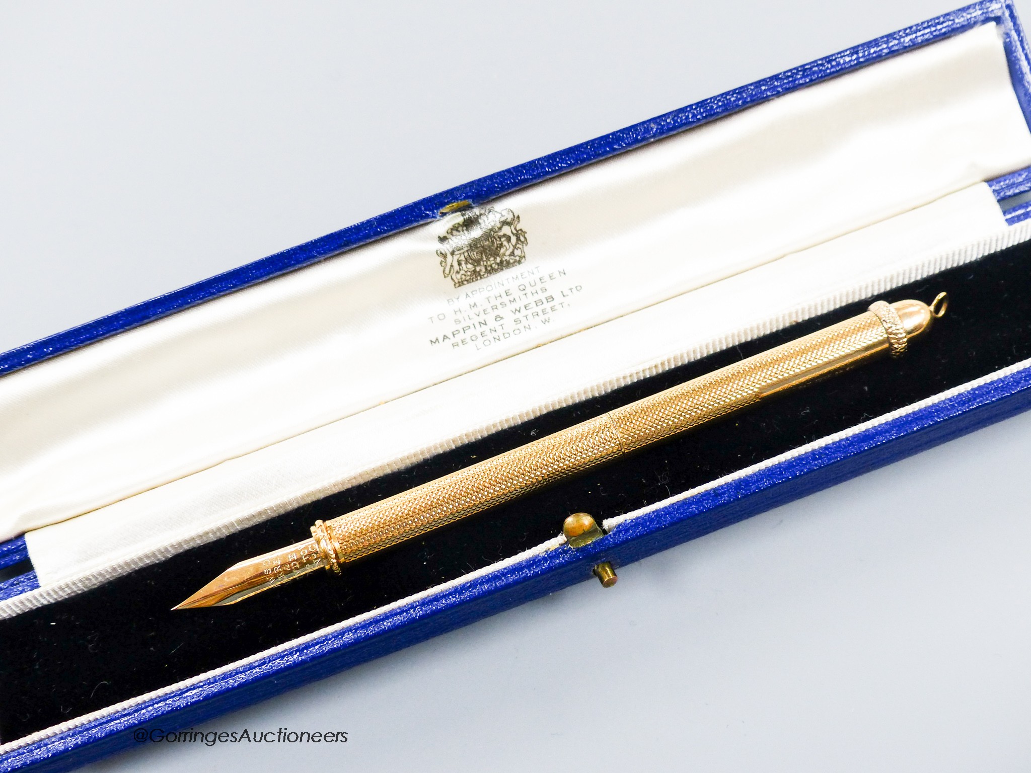 A 1960's engine turned 18k overlaid dip pen, with engraved inscription, 12.9cm, gross weight 24.4 grams.